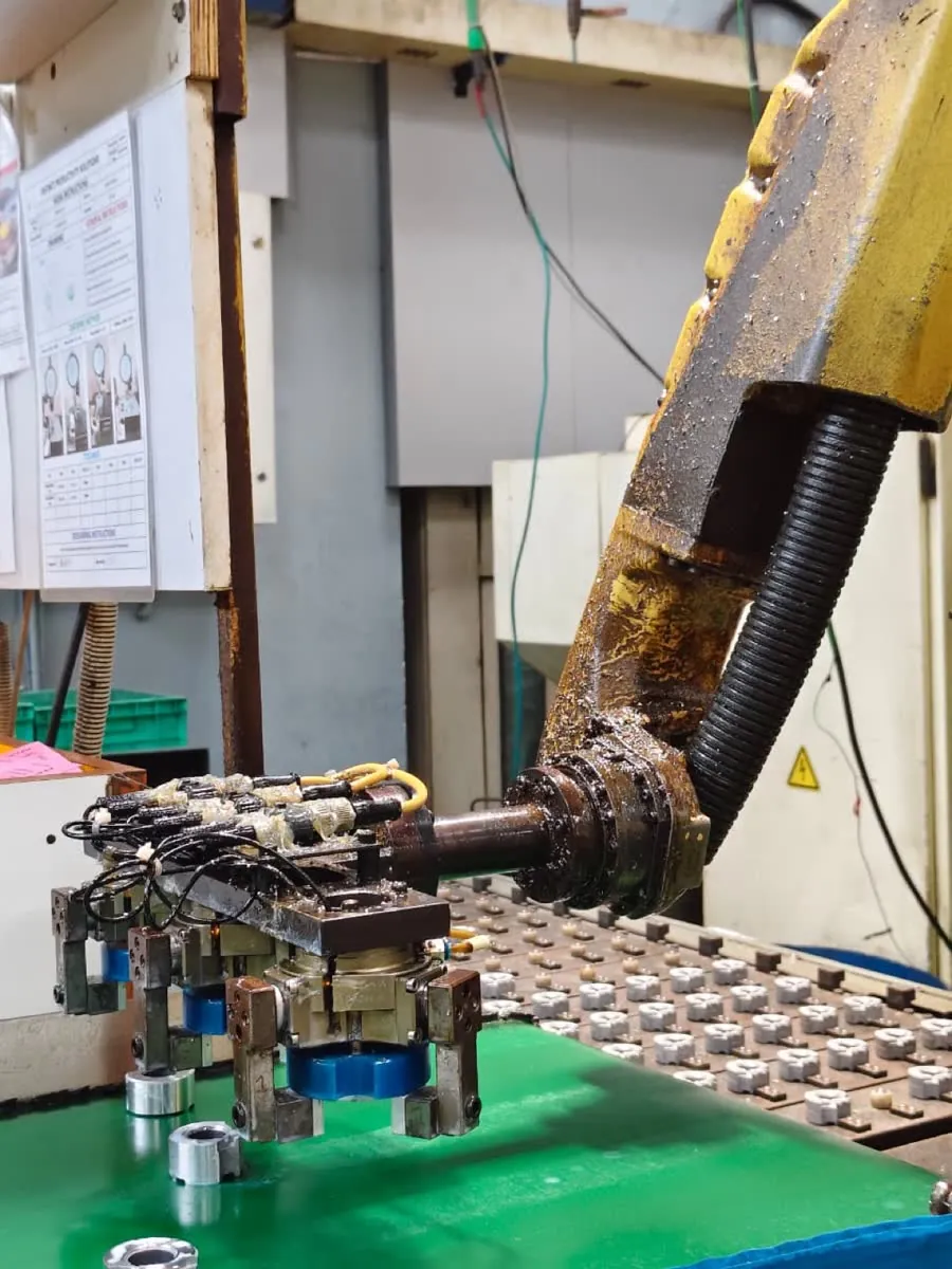 Robot gripper loading a multi-part fixture at DPS