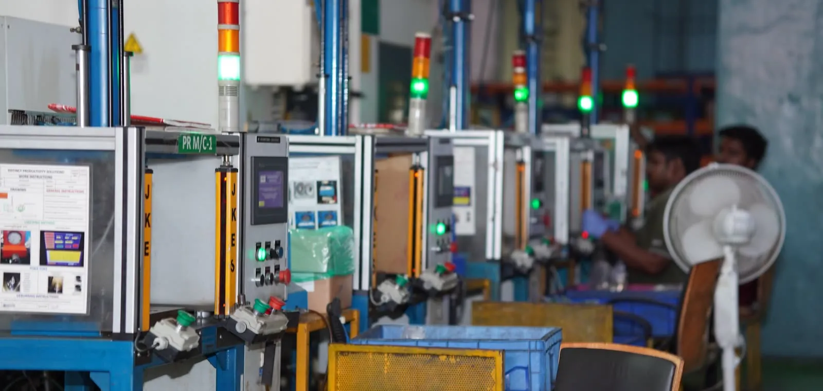 Row of press stations with andon status lights on the DPS shop floor