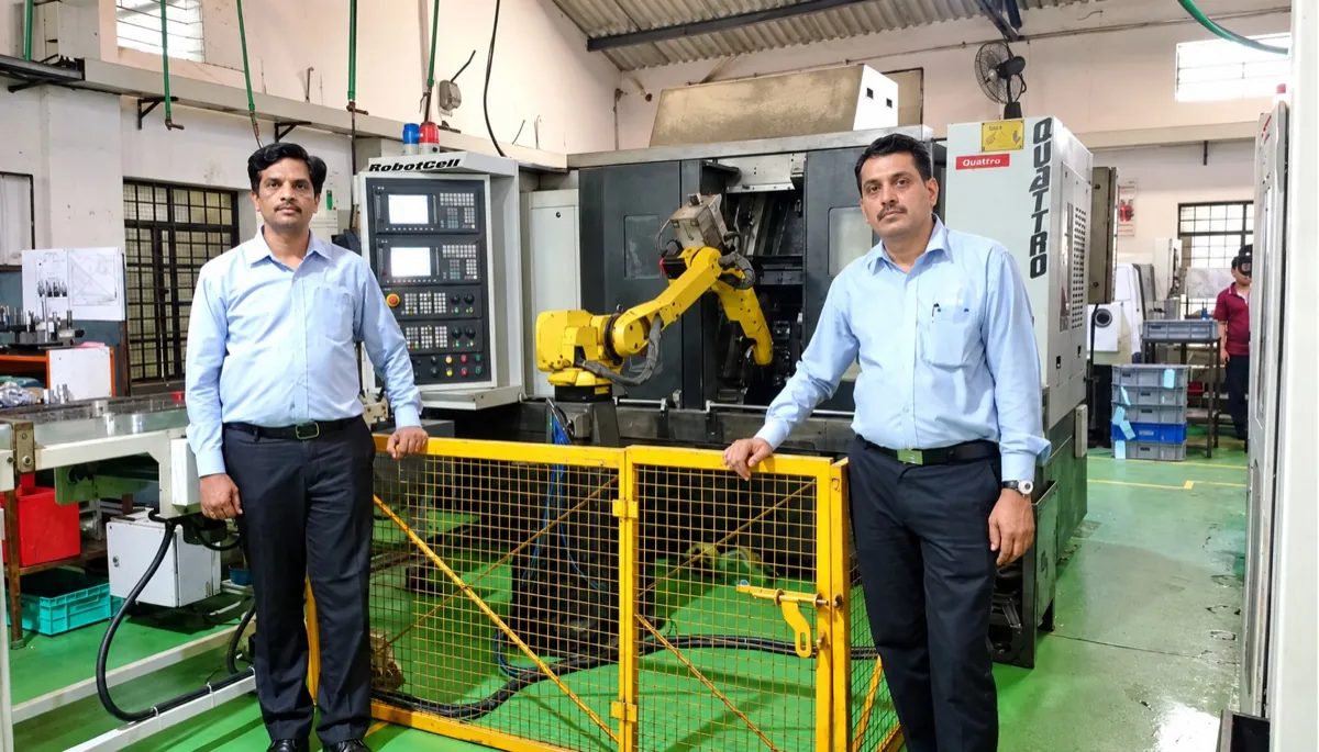 DPS team beside a robotic turning cell on the shop floor